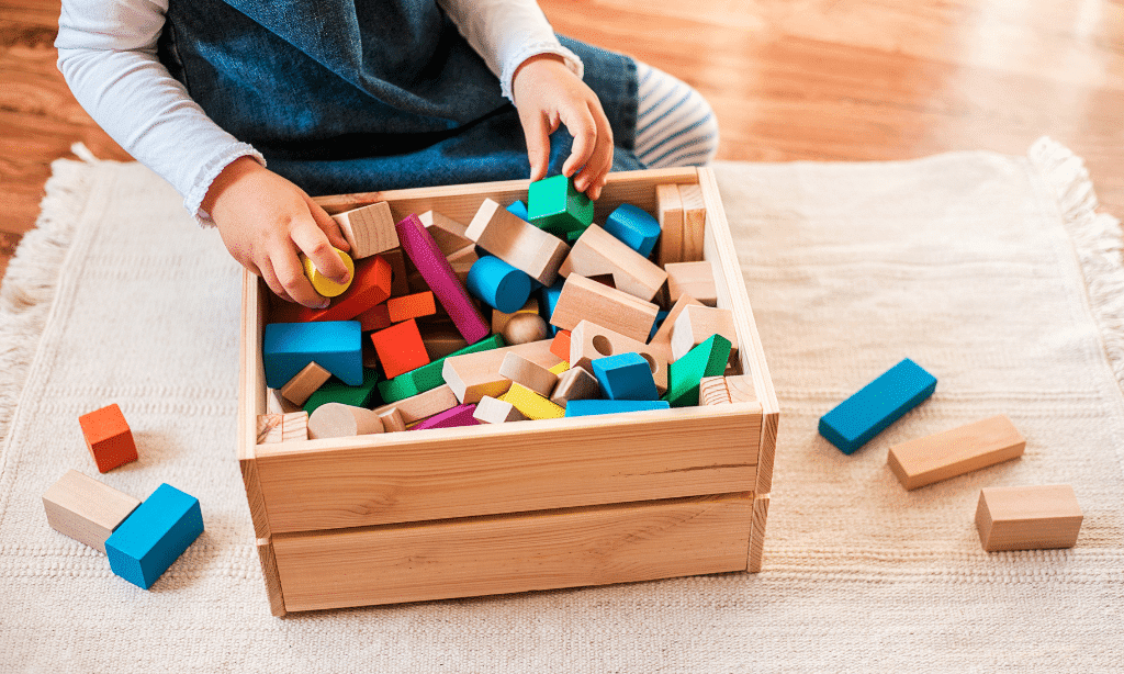 the kids is cleaning his toys - Five Ways Kids Can Help Keep Their Home Cleaner | Annapolis Cleaning Services - Bellos Cleaning - Annapolis MD