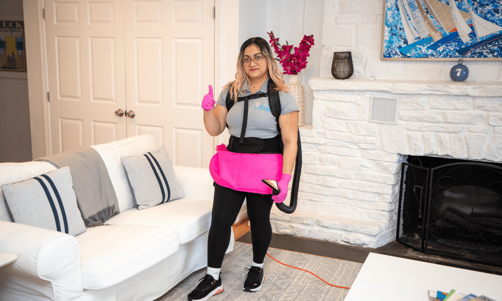 The technician is using a vacuum cleaner  -Cleaning tips - The Benefits of Hiring Professional Cleaning Services - Bellos Cleaning - Annapolis MD