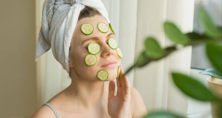 Cooling cucumber mask applied to face as natural DIY sunburn remedy