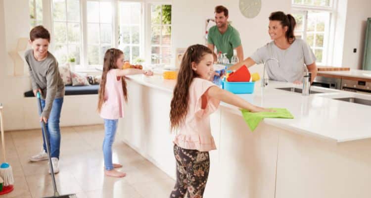 Parents and kids cleaning together as part of a weekly family routine