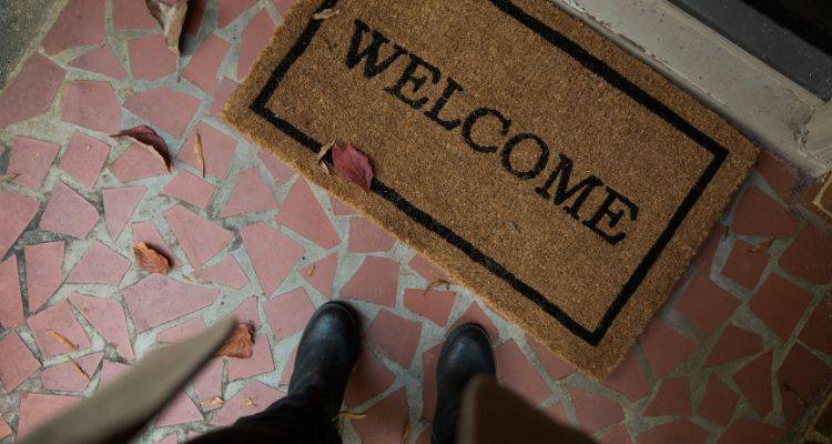 Clean entryway with fall doormat and boots