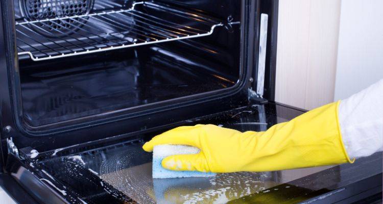 Interior cleaning of kitchen appliances during move-out clean