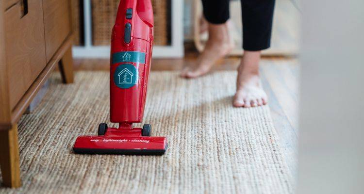 Upright vacuum cleaning a carpeted living room