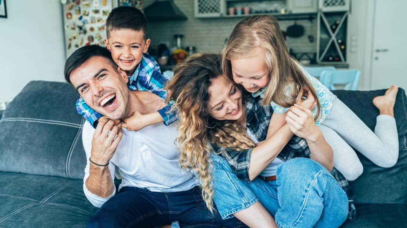 Happy family relaxing together in a tidy and freshly cleaned home