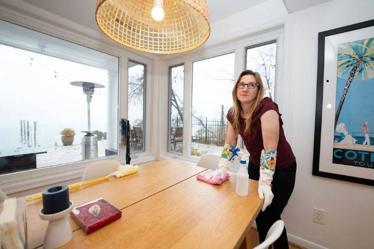 Homeowner feeling frustrated while cleaning a table before using a deep cleaning checklist in Annapolis MD